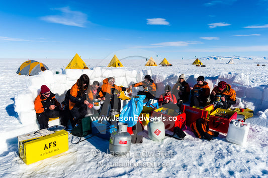 Antarctic base staff eating a meal behind a kitchen wall on the sea ice during a survival course. Windless Bight, Ross Ice Shelf, Ross Island, Antarctica.
