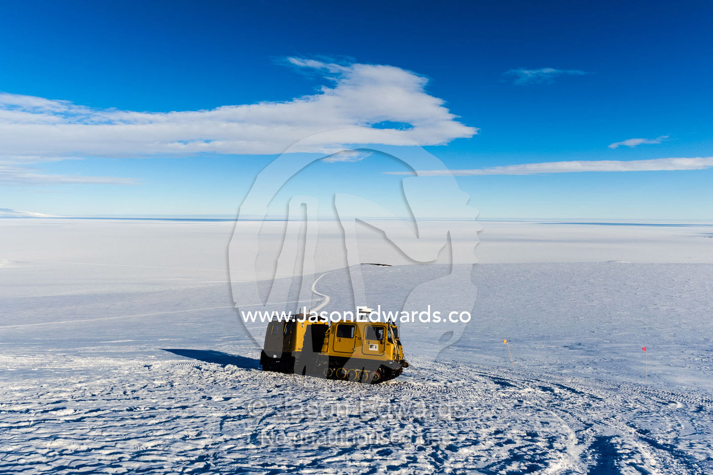 A Hagglund ice vehicle travels up a mountain slope during the Antarctic summer. Castle Rock Road, Hut Point Peninsula, Ross Island, Antarctica.