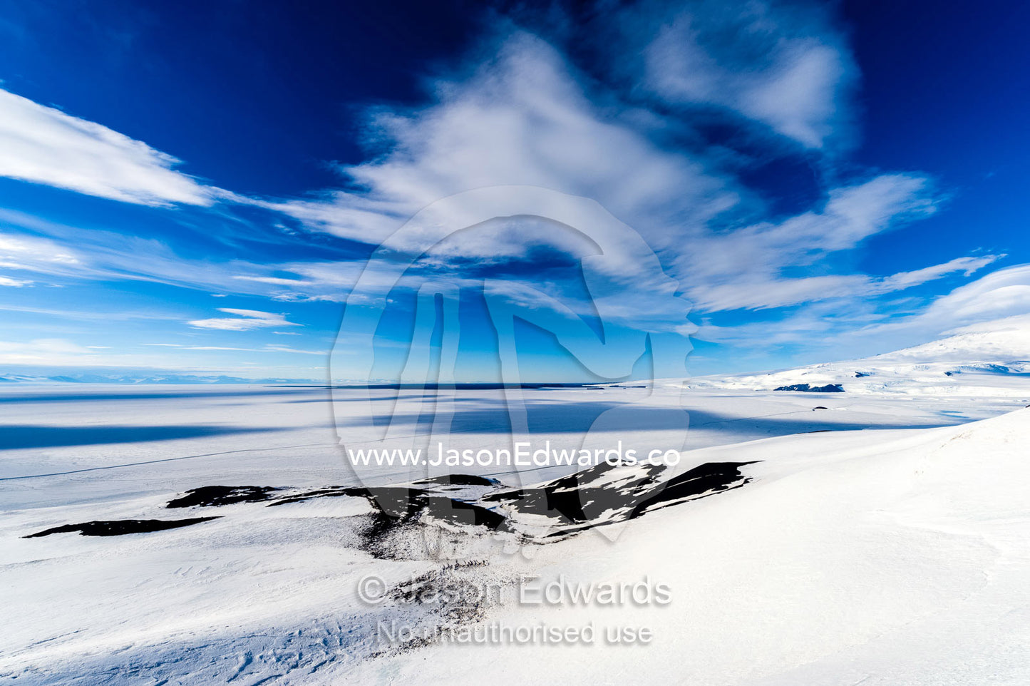 The frozen sea ice and expanding ocean ice edge during the Antarctic summer. Breached Cone, Castle Rock, Hut Point Peninsula, Ross Island, Antarctica.