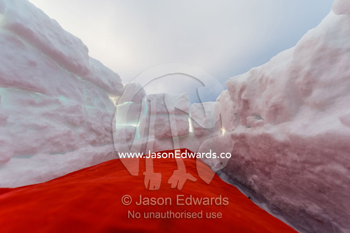 Antarctic base staff in a sleeping bag in a sleeping pit in the sea ice carved from blocks of ice. Windless Bight, Ross Ice Shelf, Ross Island, Antarctica.