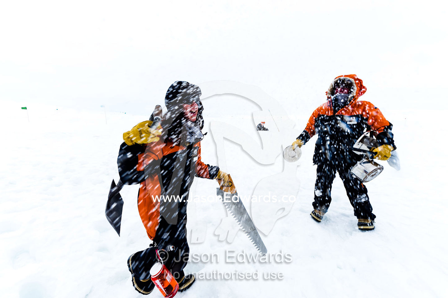 Antarctic base staff packing survival gear on the sea ice during a snow storm. Windless Bight, Ross Ice Shelf, Ross Island, Antarctica.