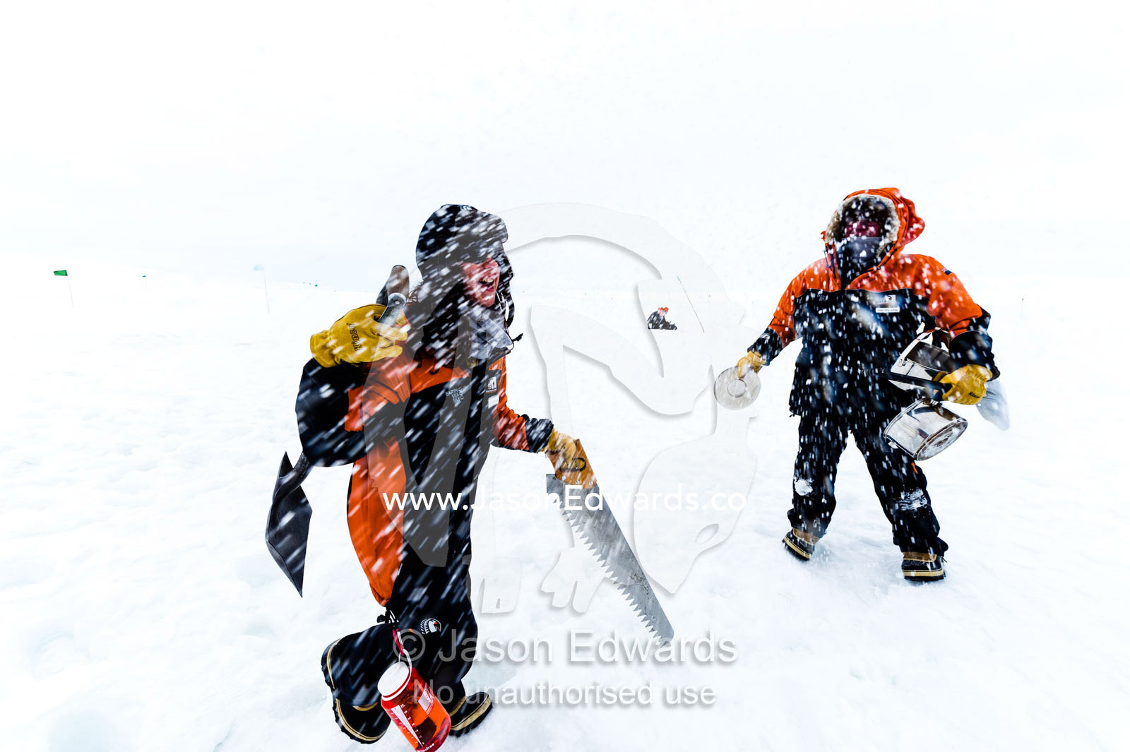 Antarctic base staff packing survival gear on the sea ice during a snow storm. Windless Bight, Ross Ice Shelf, Ross Island, Antarctica.