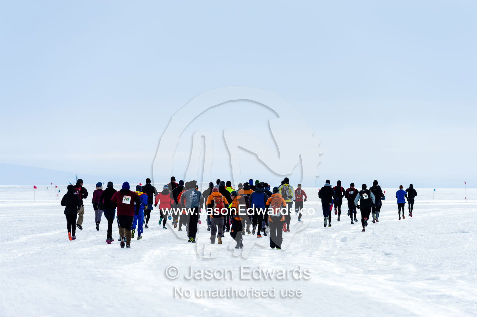 Runners from the Antarctic bases cross the sea ice during the Antarctic marathon. Ross Ice Shelf, Ross Island, Antarctica.