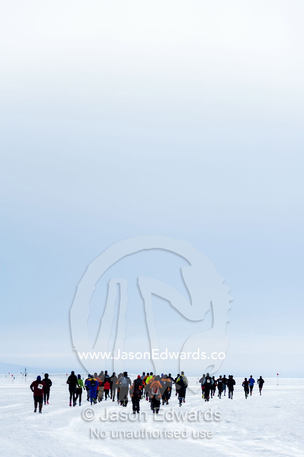 Runners from the Antarctic bases cross the sea ice during the Antarctic marathon. Ross Ice Shelf, Ross Island, Antarctica.