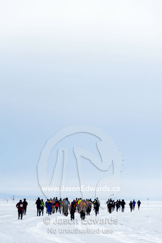 Runners from the Antarctic bases cross the sea ice during the Antarctic marathon. Ross Ice Shelf, Ross Island, Antarctica.