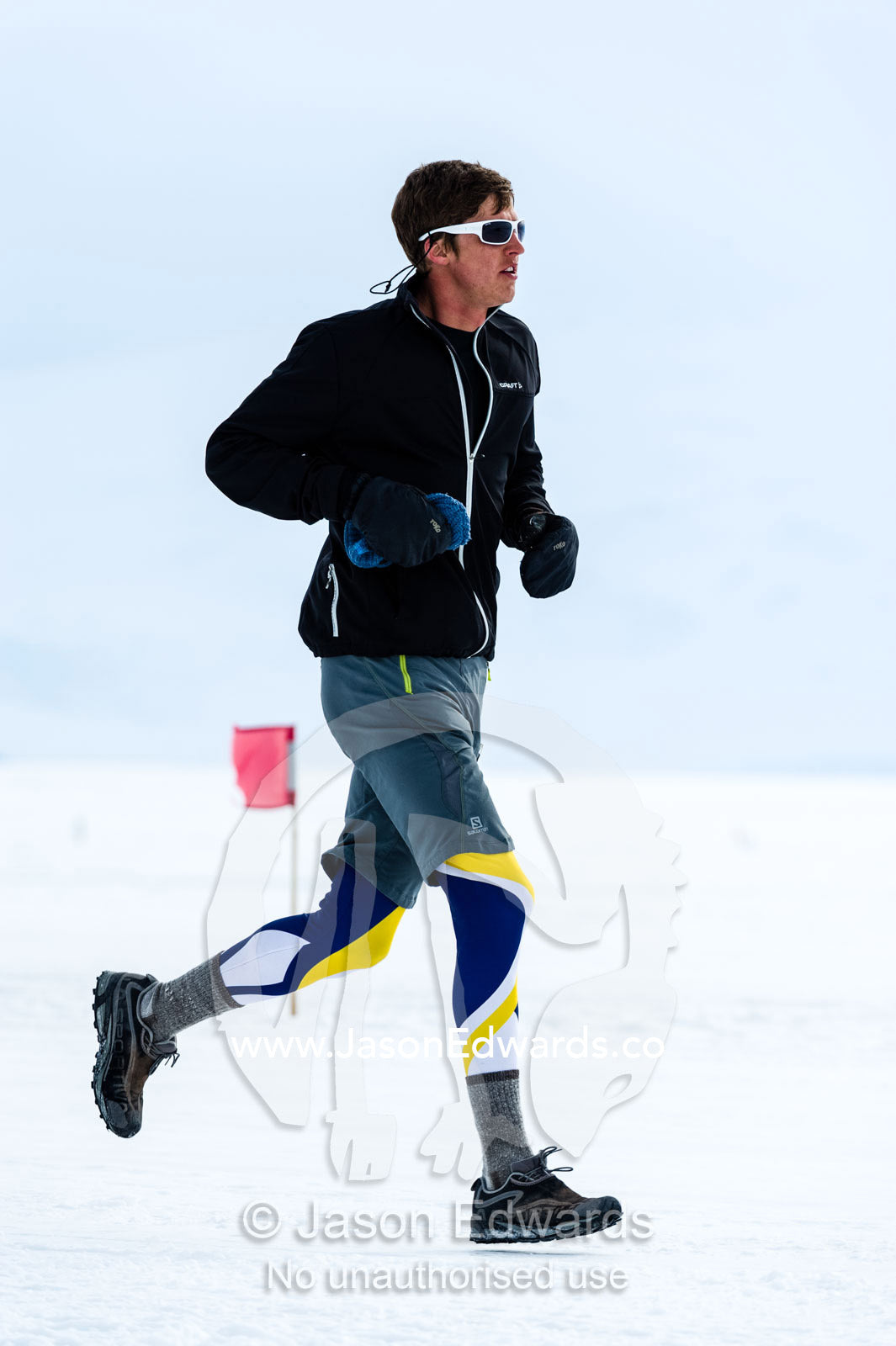 A solitary runner crosses the sea ice during the Antarctic marathon. Ross Ice Shelf, Ross Island, Antarctica.