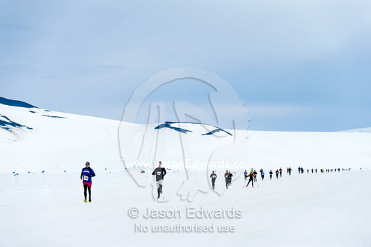 Runners from the Antarctic bases cross the sea ice during the Antarctic marathon. Ross Ice Shelf, Ross Island, Antarctica.