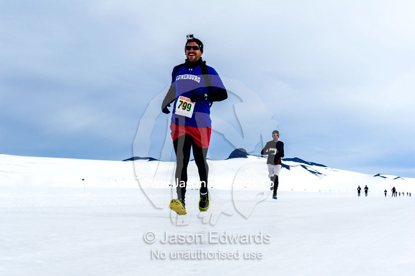 Runners cross treacherous slippery ice during the Antarctic marathon. Ross Ice Shelf, Ross Island, Antarctica.