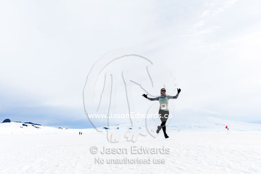A solitary runner crosses the sea ice during the Antarctic marathon. Ross Ice Shelf, Ross Island, Antarctica.