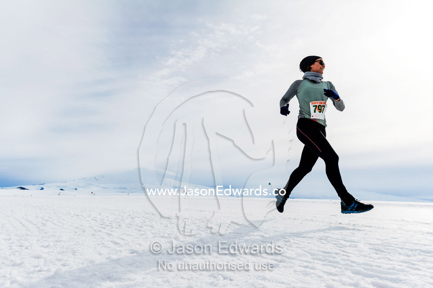 A solitary runner crosses the sea ice during the Antarctic marathon. Ross Ice Shelf, Ross Island, Antarctica.