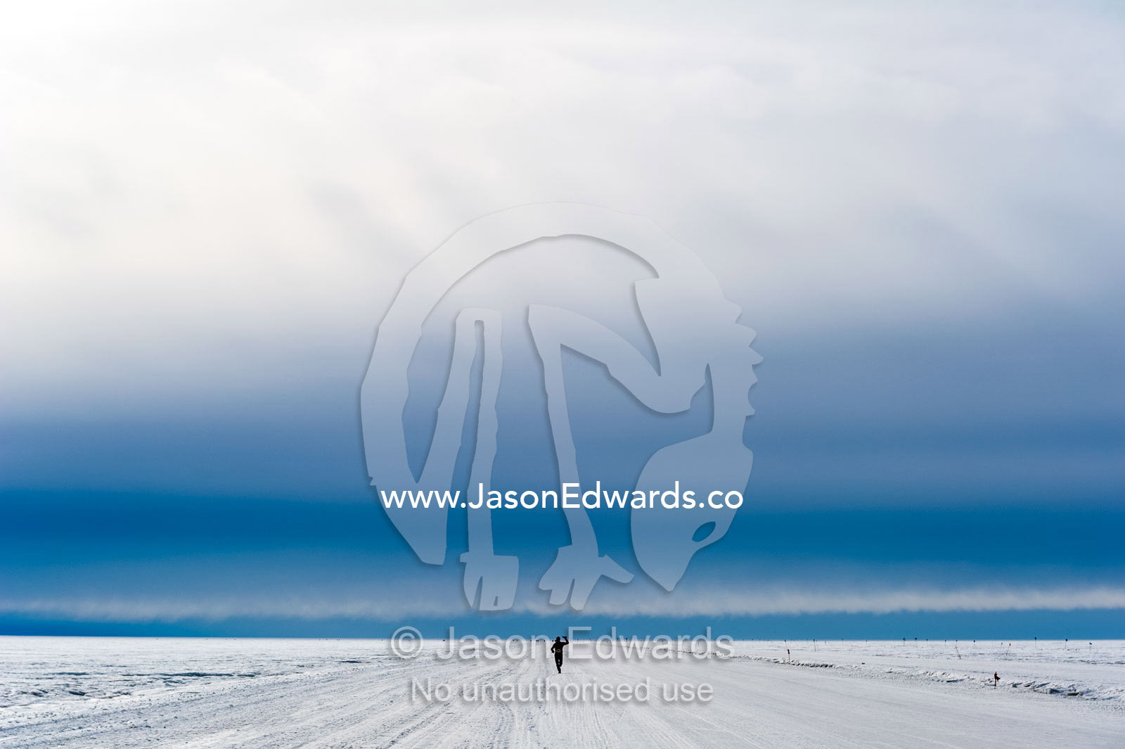 A solitary runner crosses the sea ice during the Antarctic marathon. Ross Ice Shelf, Ross Island, Antarctica.