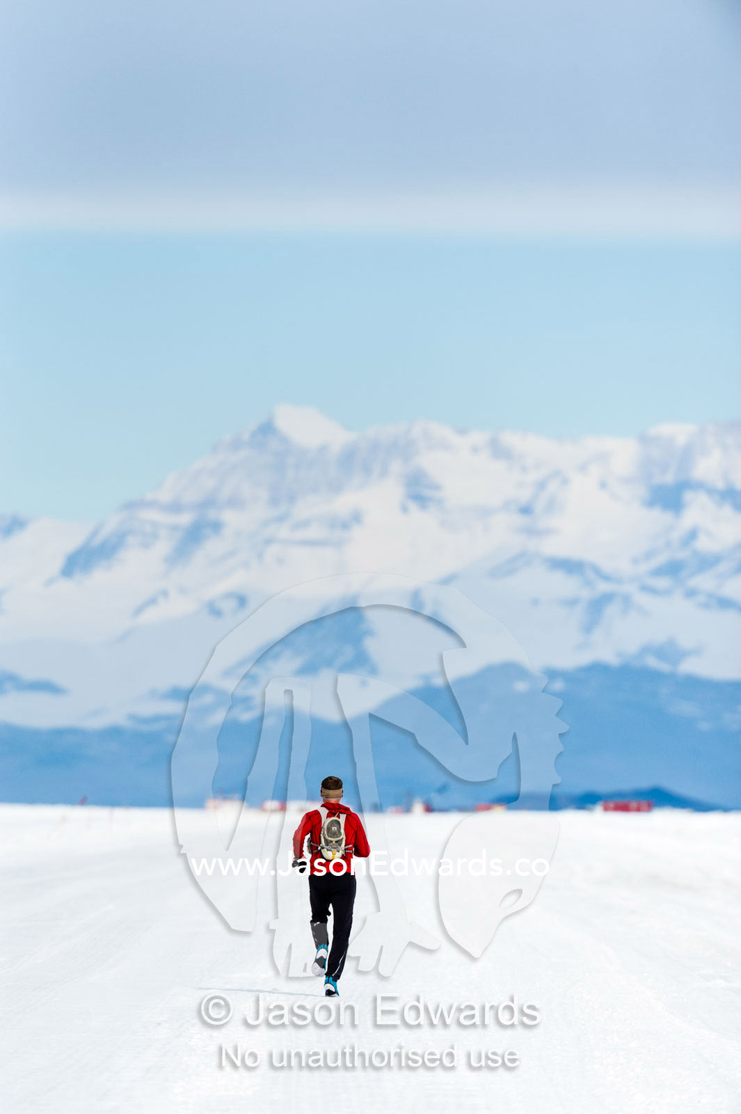 A solitary runner crosses the sea ice during the Antarctic marathon. Royal Society Range, Ross Ice Shelf, Ross Island, Antarctica.