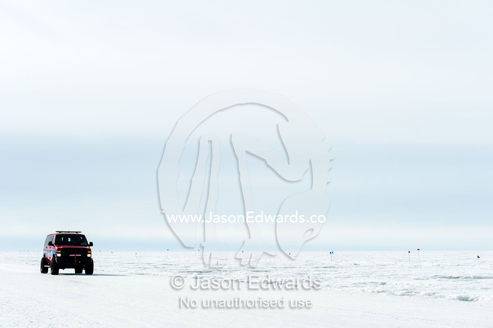 A support vehicle crosses the sea ice to monitor runners in the Antarctic marathon. Ross Ice Shelf, Ross Island, Antarctica.