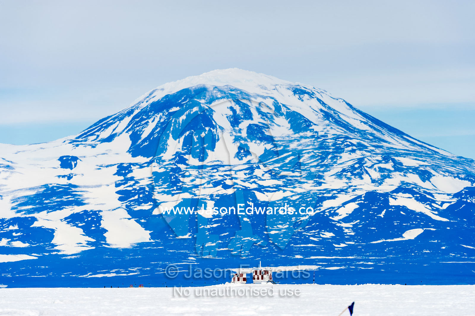 The checkered aircraft control tower of Antarctic airstrip on the sea ice. Royal Society Range, Pegasus Field, McMurdo Ice Shelf, Ross Island, McMurdo Sound, Antarctica.