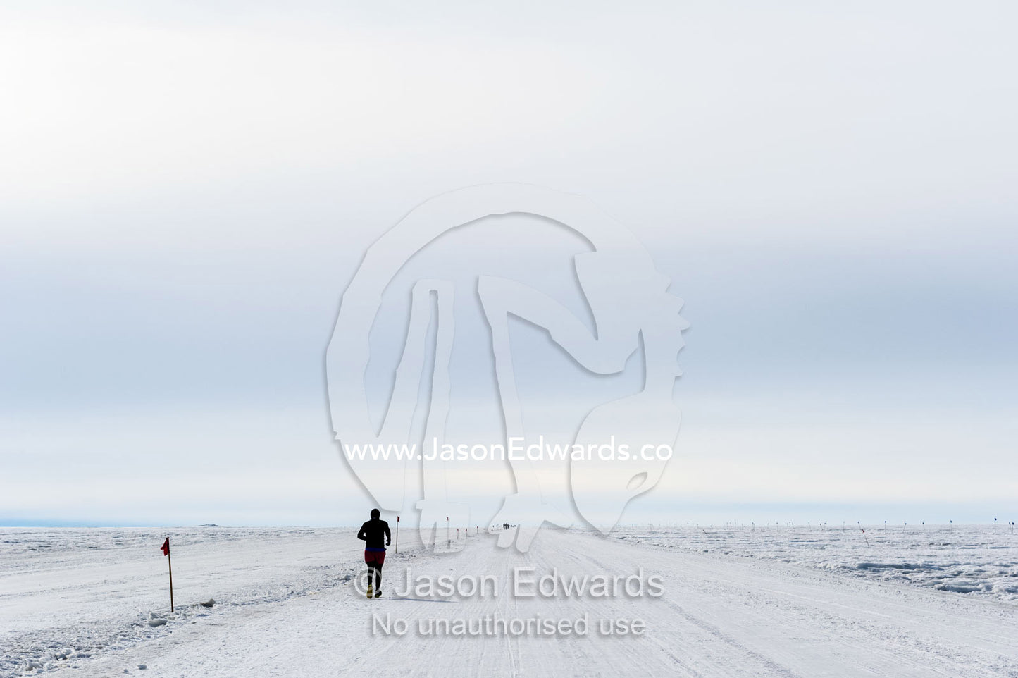 A solitary runner crosses the sea ice during the Antarctic marathon. Ross Ice Shelf, Ross Island, Antarctica.