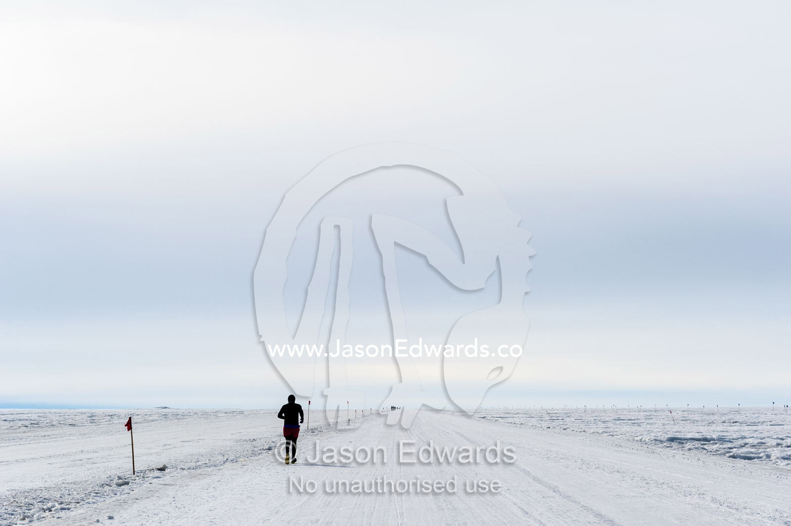 A solitary runner crosses the sea ice during the Antarctic marathon. Ross Ice Shelf, Ross Island, Antarctica.