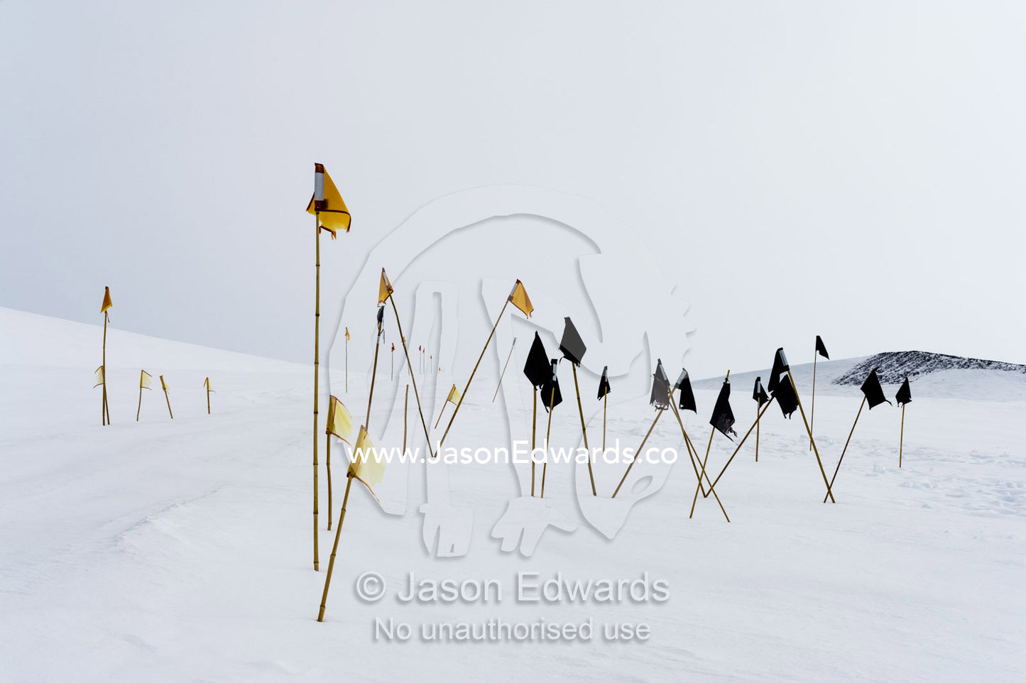 Warning flags mark dangerous crevasse on a mountainside. Castle Rock Road, Hut Point Peninsula, Ross Island, Antarctica.