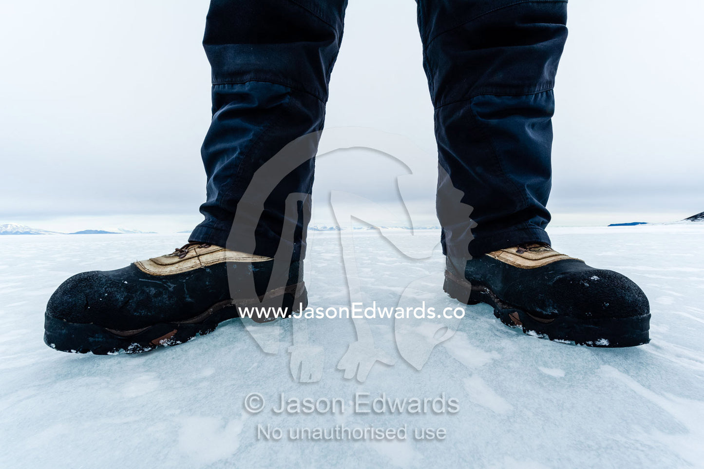 Extreme cold weather boots enable researcher to work on the sea ice. Turtle Rock, Erebus Bay, McMurdo Sound, Ross Island, Antarctica.