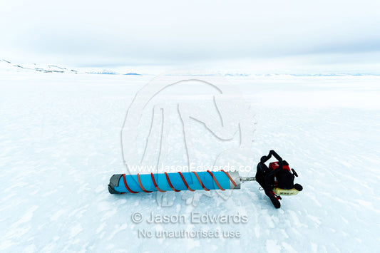 A drill used for extracting sea ice core samples resting on a frozen plain. Turtle Rock, Erebus Bay, McMurdo Sound, Ross Island, Antarctica.