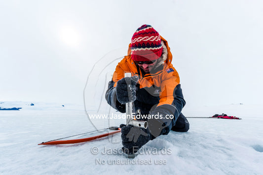 Researchers drill core samples from the sea ice to collect extremophiles from beneath the ice to study. Turtle Rock, Erebus Bay, McMurdo Sound, Ross Island, Antarctica.