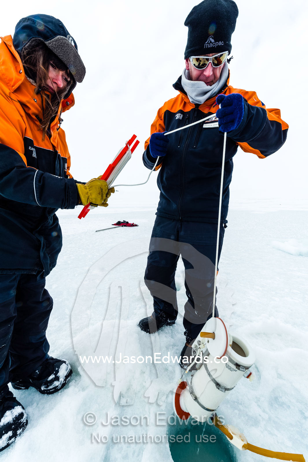 Researchers drill core samples from the sea ice to collect extremophiles from the ocean beneath the ice to study. Turtle Rock, Erebus Bay, McMurdo Sound, Ross Island, Antarctica.