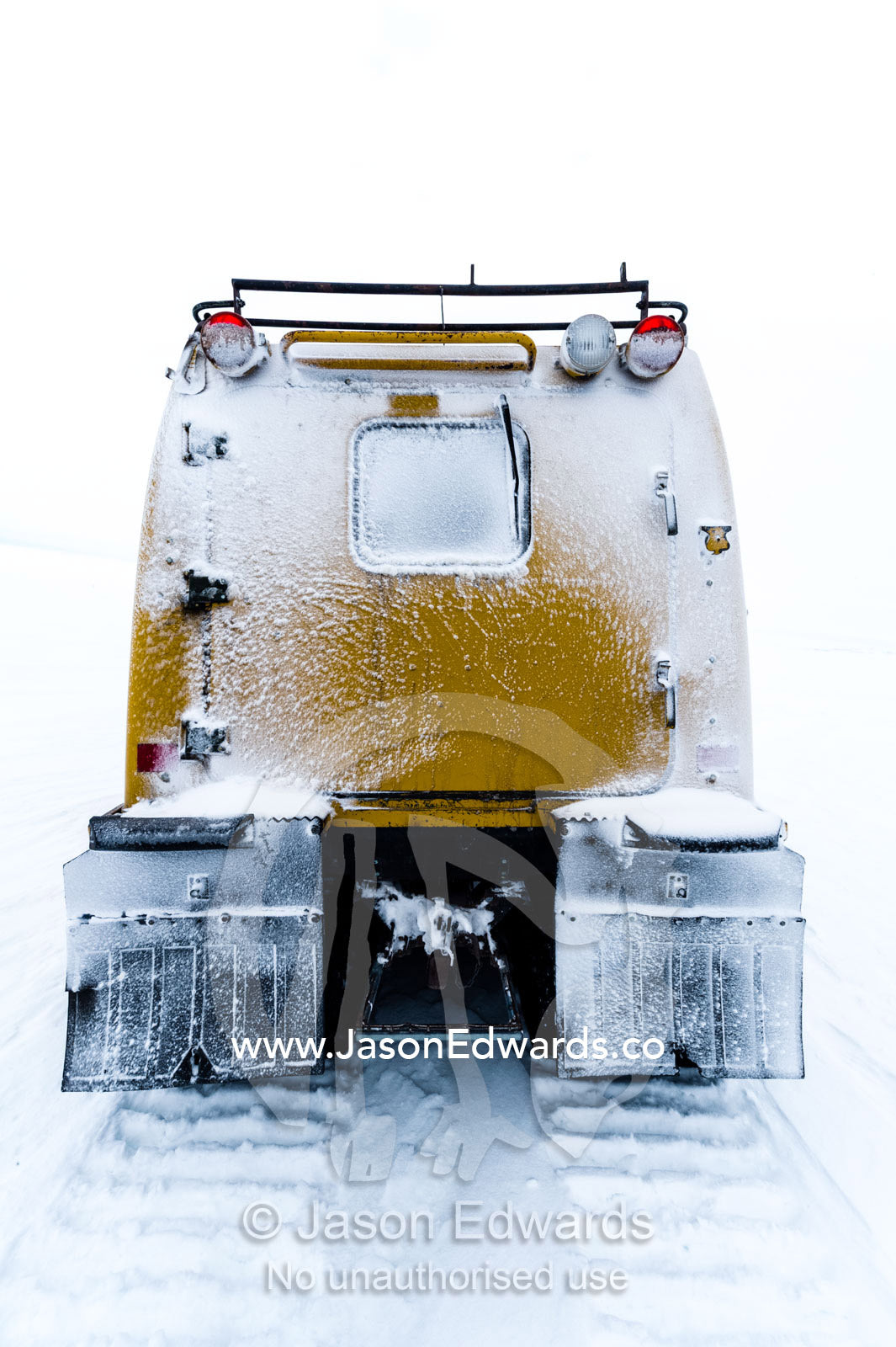 A Hagglund ice vehicle travels across the frozen sea ice during the Antarctic summer. Castle Rock Road, Hut Point Peninsula, Ross Island, Antarctica.