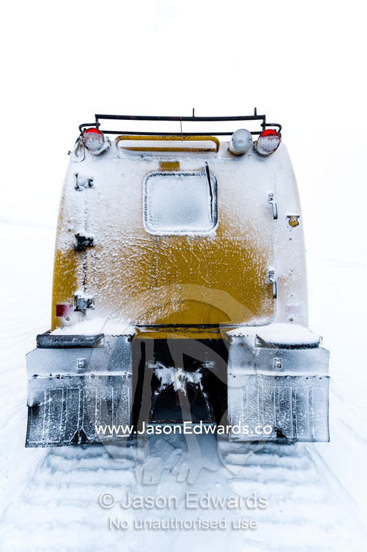 A Hagglund ice vehicle travels across the frozen sea ice during the Antarctic summer. Castle Rock Road, Hut Point Peninsula, Ross Island, Antarctica.
