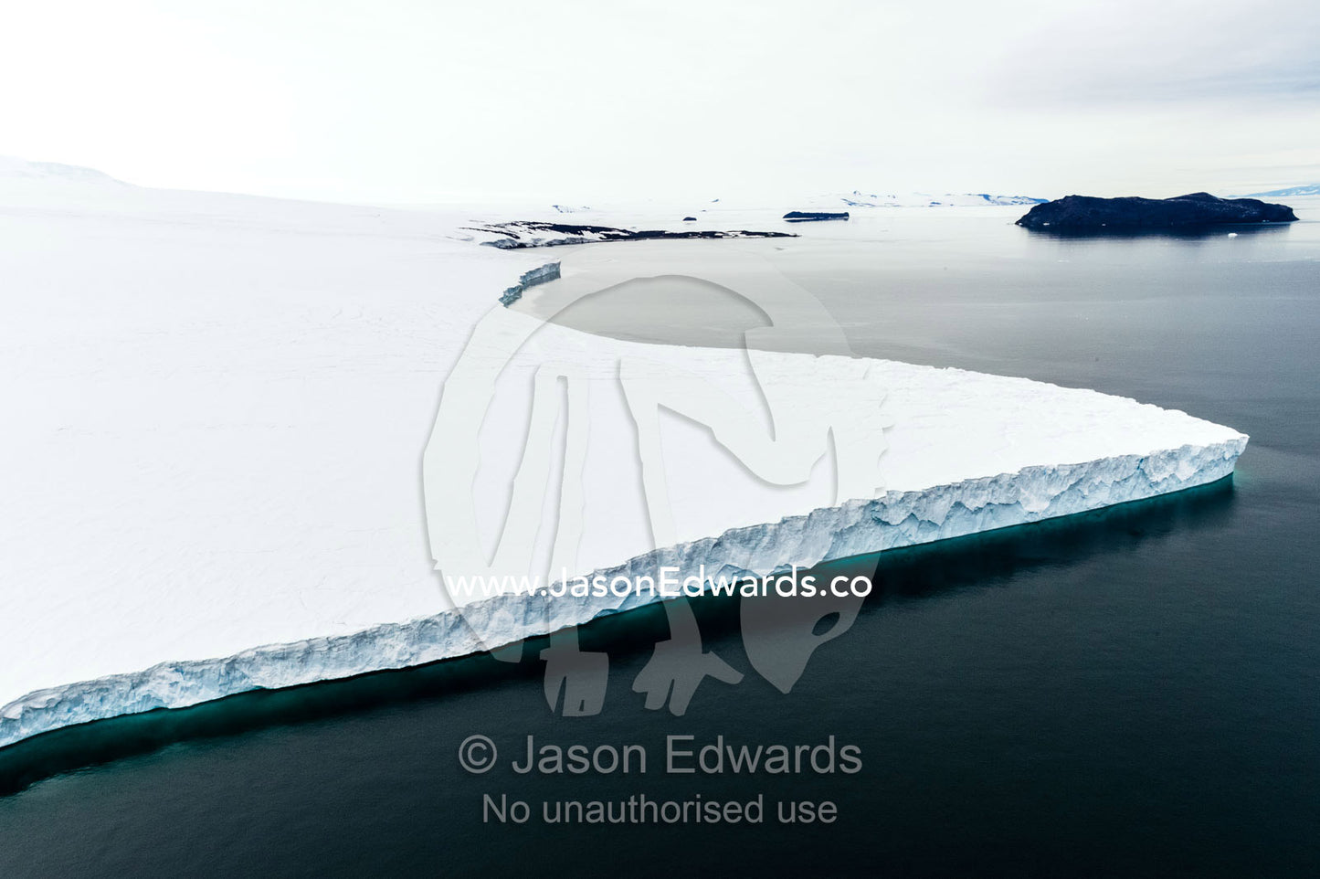 Towering ocean ice cliffs and crevasse fields of a glacier flowing off the slopes of Mount Erebus an active volcano. North Bay, Cape Evans, Ross Island, Antarctica.