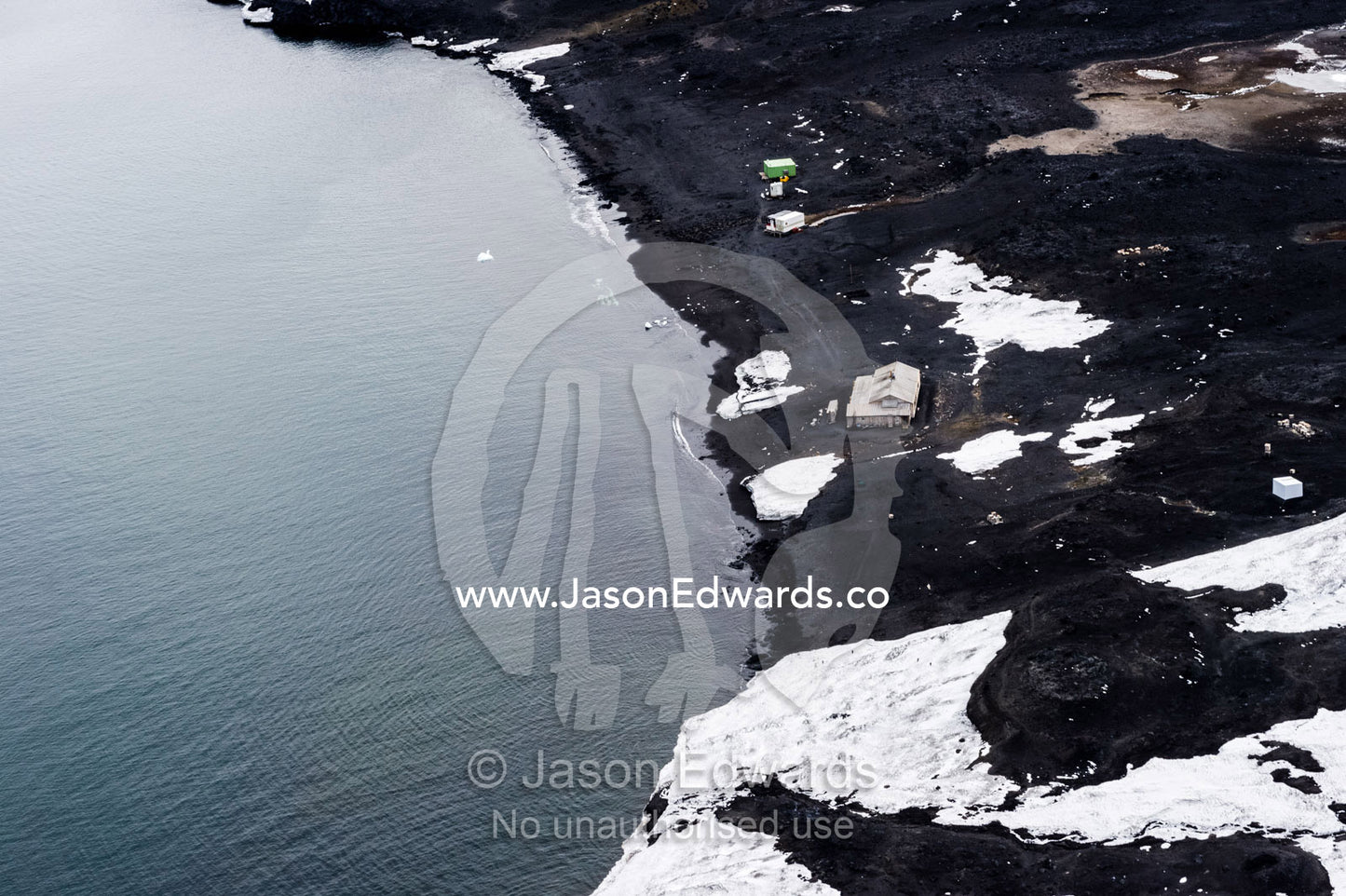 An aerial view of Antarctic explorer Robert Falcon Scott's Hut on the shore of the sea ice. North Bay, Cape Evans, Ross Island, Antarctica.