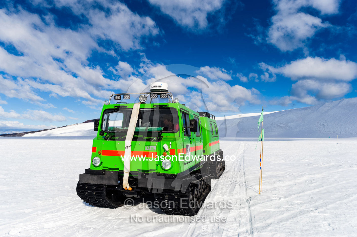 A Hagglund ice vehicle travels across the Ross Ice Shelf during the Antarctic summer. Windless Bight, Ross Ice Shelf, Ross Island, Antarctica.