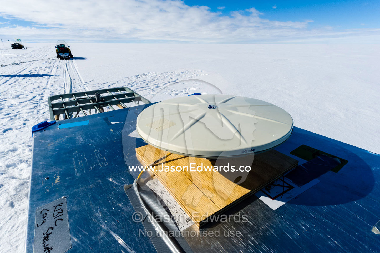 A skidoo tows a radar to send radio waves to the base of the ice to measure the return time and therefore the thickness. Windless Bight, Ross Ice Shelf, Ross Island, Antarctica.