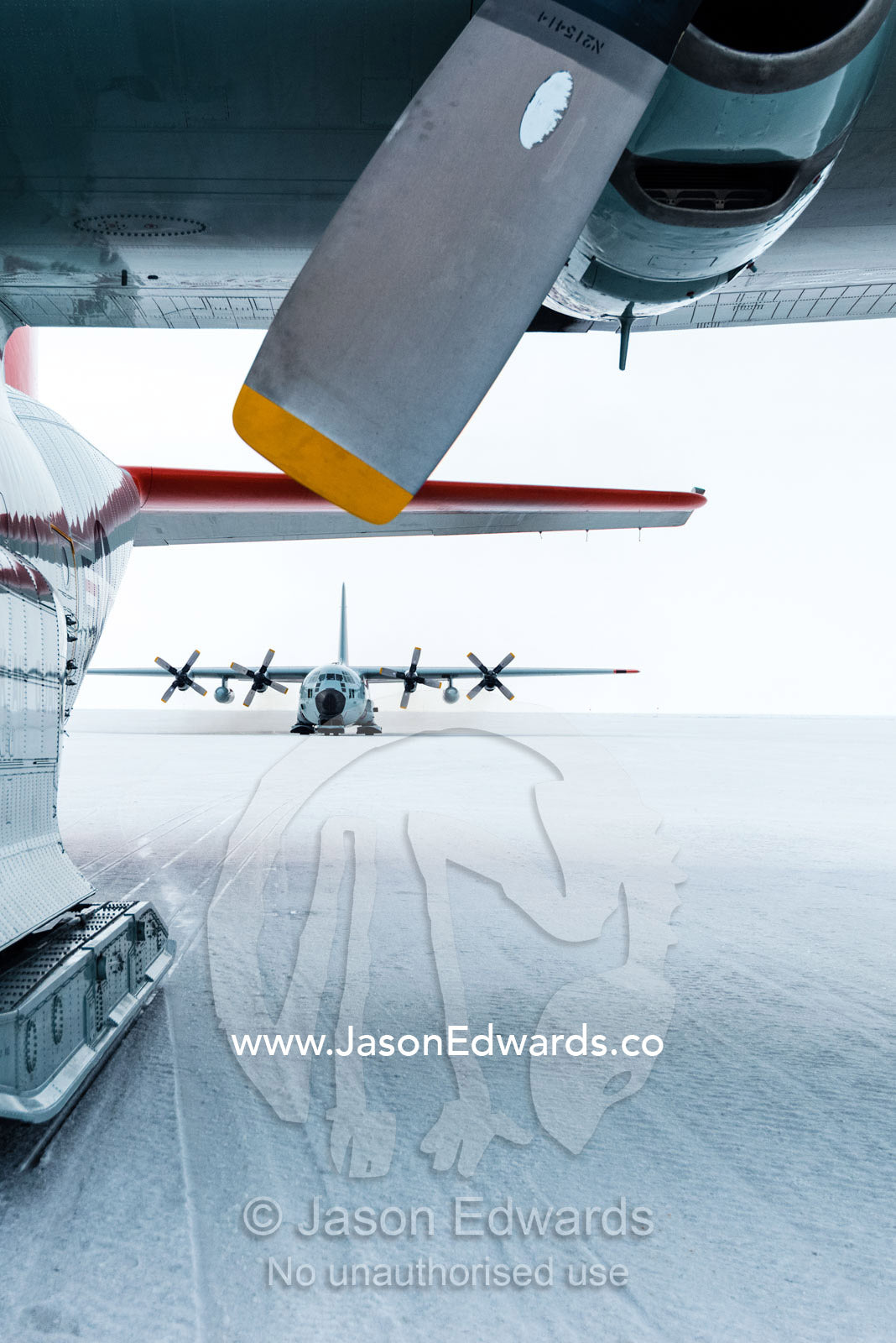 US Air force Hercules resting on skis on a sea ice tarmac. Royal Society Range, Pegasus Field, McMurdo Ice Shelf, Ross Island, McMurdo Sound, Antarctica.