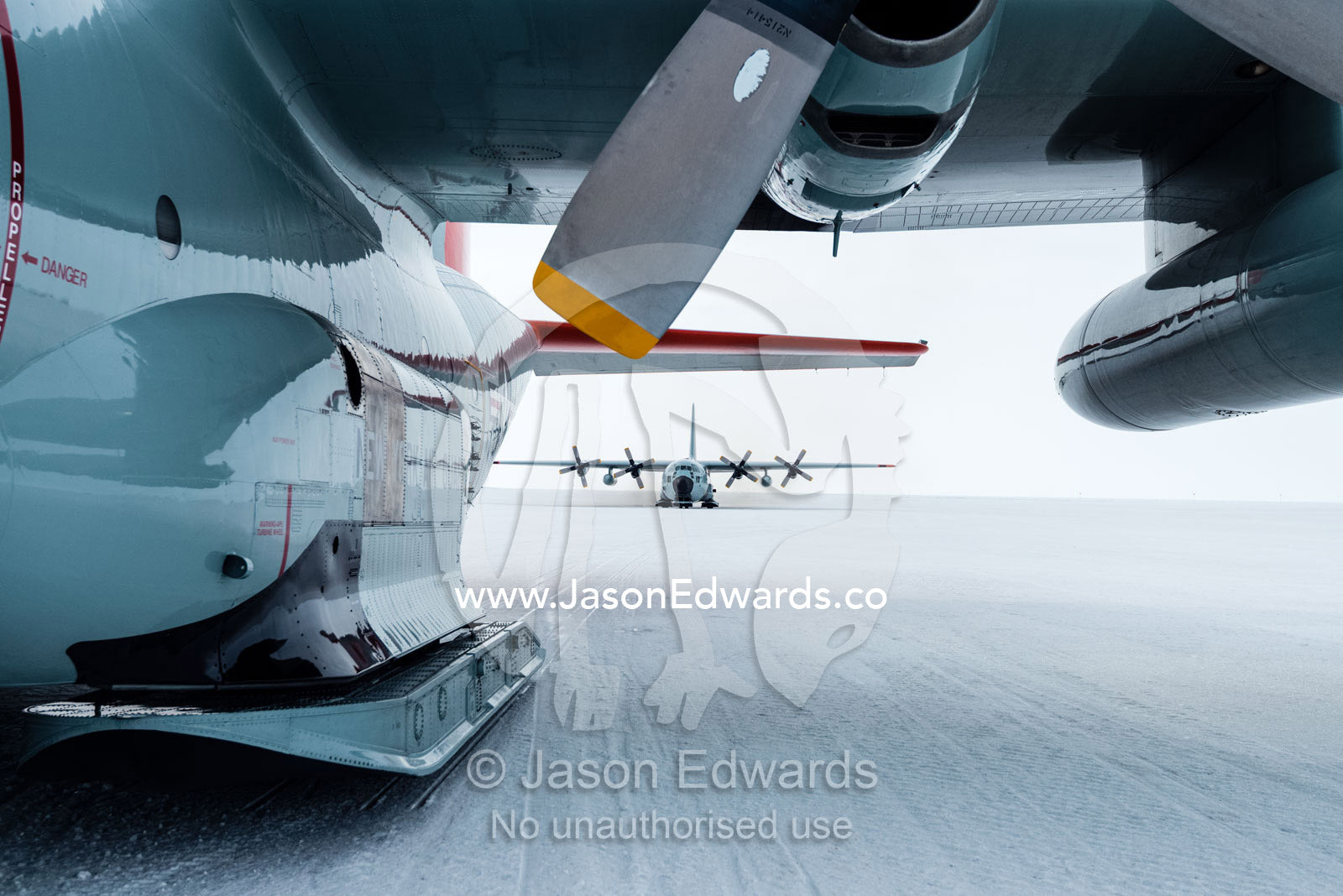 US Air force Hercules resting on skis on a sea ice tarmac. Royal Society Range, Pegasus Field, McMurdo Ice Shelf, Ross Island, McMurdo Sound, Antarctica.