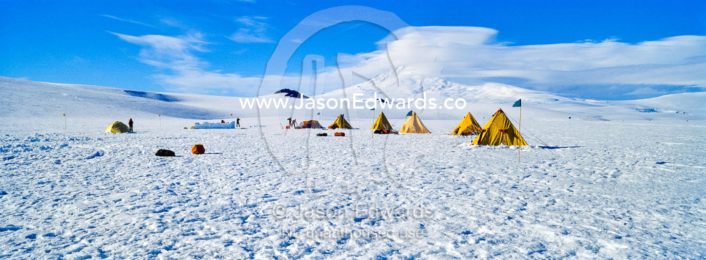 Bright yellow tents lined-up on the Ross Ice Shelf during a survival training course. Windless Bight, Ross Ice Shelf, Ross Island, Antarctica.