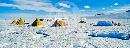 Bright yellow tents lined-up on the Ross Ice Shelf during a survival training course. Windless Bight, Ross Ice Shelf, Ross Island, Antarctica.