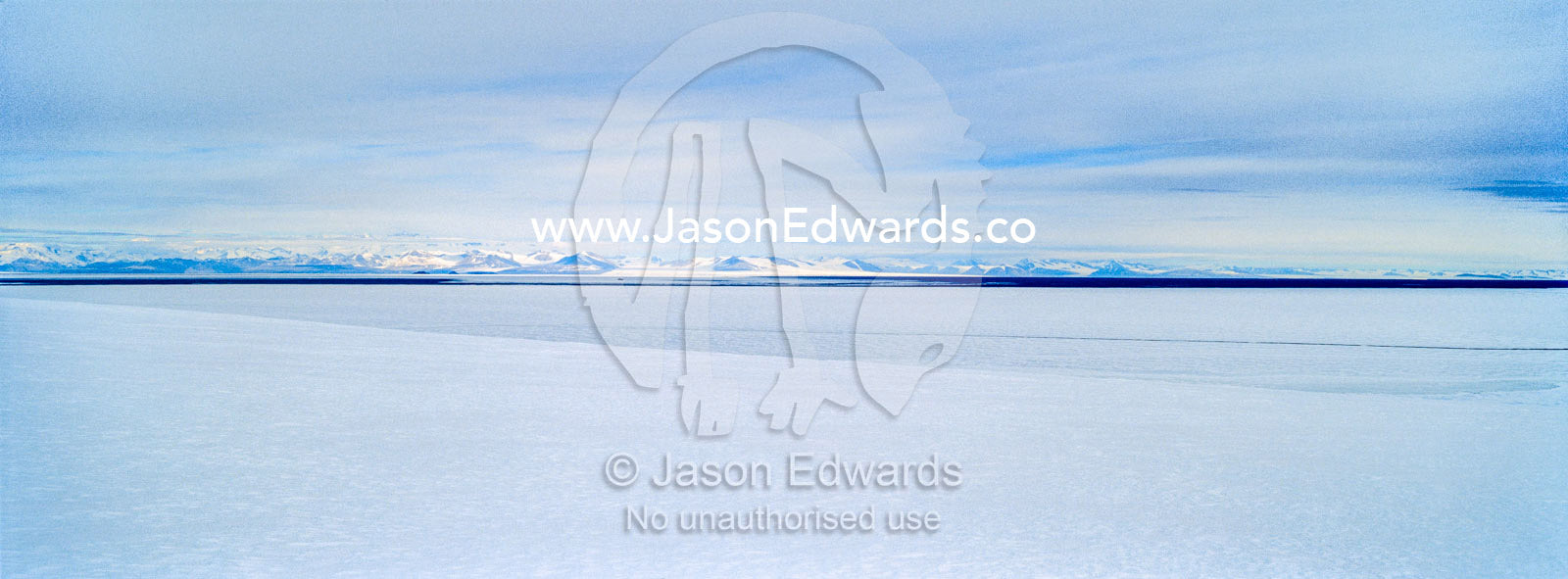 Snow drifts gather on the sea ice in Antarctica. Royal Society Range, McMurdo Sound, Ross Island, Antarctica.