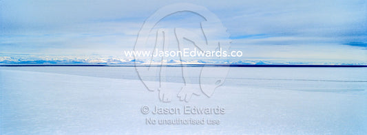 Snow drifts gather on the sea ice in Antarctica. Royal Society Range, McMurdo Sound, Ross Island, Antarctica.