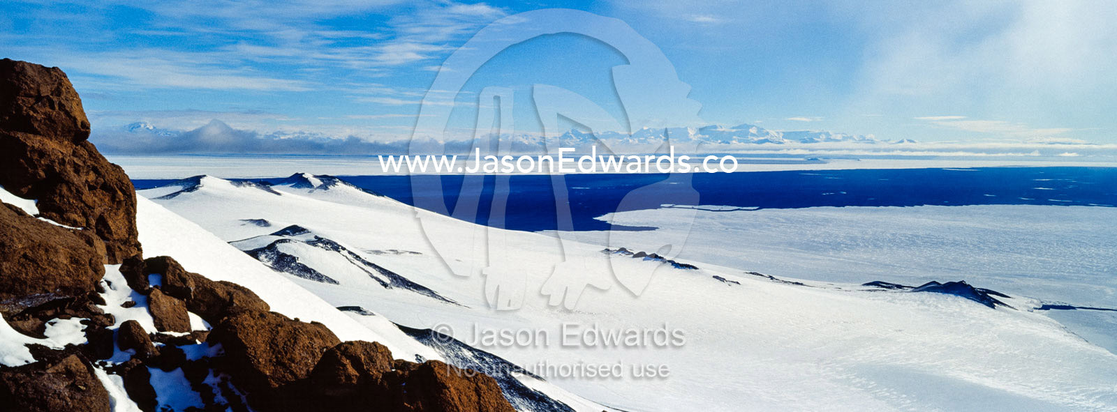A snow and ice covered mountain plateau overlooking the Ross Sea. Royal Society Range, Castle Rock, Hut Point Peninsula, Ross Island, Antarctica.