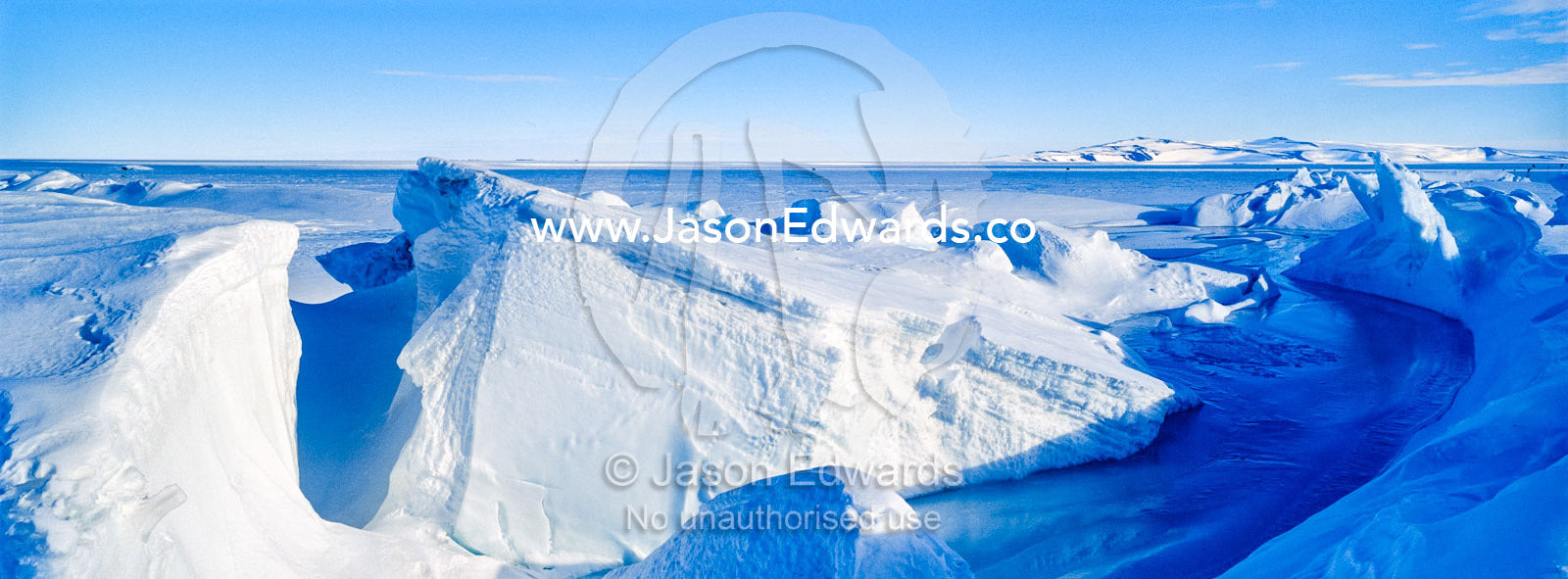Enormous blocks of ice are pushed skyward along pressure ridges as the sea ice thins and forms melt pools. Pram Point, McMurdo Sound, Ross Island, Antarctica.