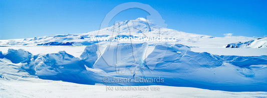 Pressure ridges in the sea ice form a barrier to Mount Erebus an active volcano in Antarctica. Mount Erebus, Erebus Bay, McMurdo Sound, Ross Island, Antarctica.