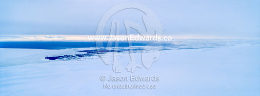 Cloud descends over the frozen sea ice and ocean ice edge. McMurdo Sound, Ross Sea, Antarctica.