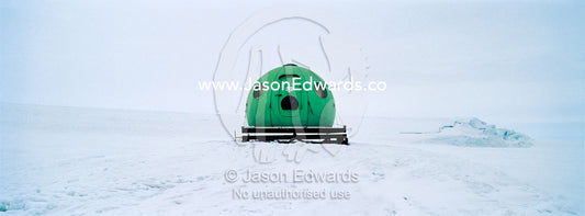 A bright green Apple hut also called an igloo satellite cabin, are light-weight field shelters hemispherical in shape. Windless Bight, Ross Ice Shelf, Ross Island, Antarctica.