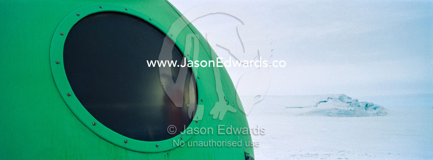 A bright green Apple hut also called an igloo satellite cabin, are light-weight field shelters hemispherical in shape. Windless Bight, Ross Ice Shelf, Ross Island, Antarctica.
