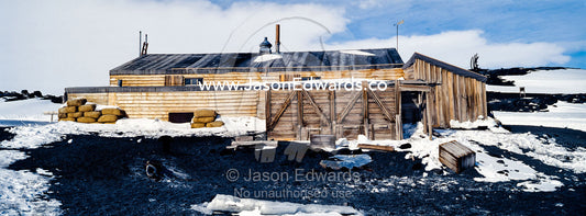 The weathered walls and window shutters of the Antarctic explorer Robert Falcon Scott's hut surrounded by snow. Scott's Hut, Cape Evans, Ross Island, Antarctica.