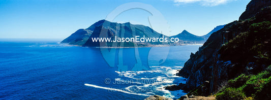Wave foam trapped in currents along the base of coastal cliffs. Sentinel Peak, Hout Bay, Chapmans Peak Drive, Chapmans Peak Mountain Range, Cape Town, Western Cape, South Africa.