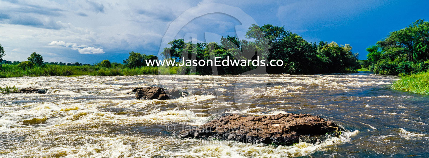 The raging current of the Zambezi River after heavy rain falls. Zambezi River, Victoria Falls, Mosi-oa-Tunya National Park, Zambia.