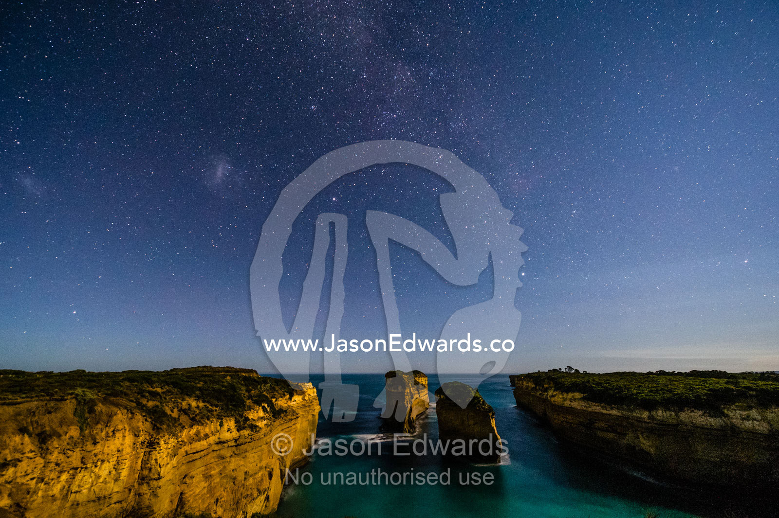 The Milky Way stretches over the coastline near the  Twelve Apostles, a collection of limestone stacks. Twelve Apostles, Port Campbell National, Great Ocean Road, Victoria, Australia.