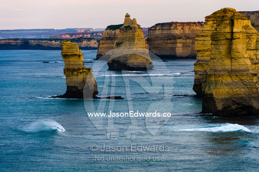Waves breaking at the base of the Twelve Apostles limestone pillars. Twelve Apostles, Port Campbell National, Great Ocean Road, Victoria, Australia.