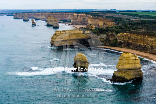 An aerial view of the sheer limestone cliffs and the Twelve Apostles pillars. Twelve Apostles, Port Campbell National, Great Ocean Road, Victoria, Australia.