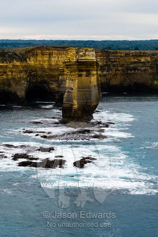An aerial view of the ocean and the erosion on the sheer limestone cliffs and bays. Twelve Apostles, Port Campbell National, Great Ocean Road, Victoria, Australia.